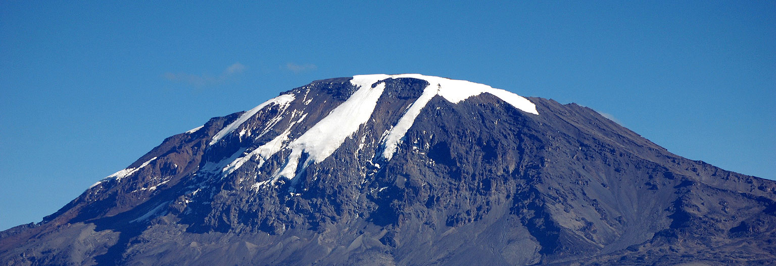 Snow-capped summit of Mount Kilimanjaro beneath a clear blue sky