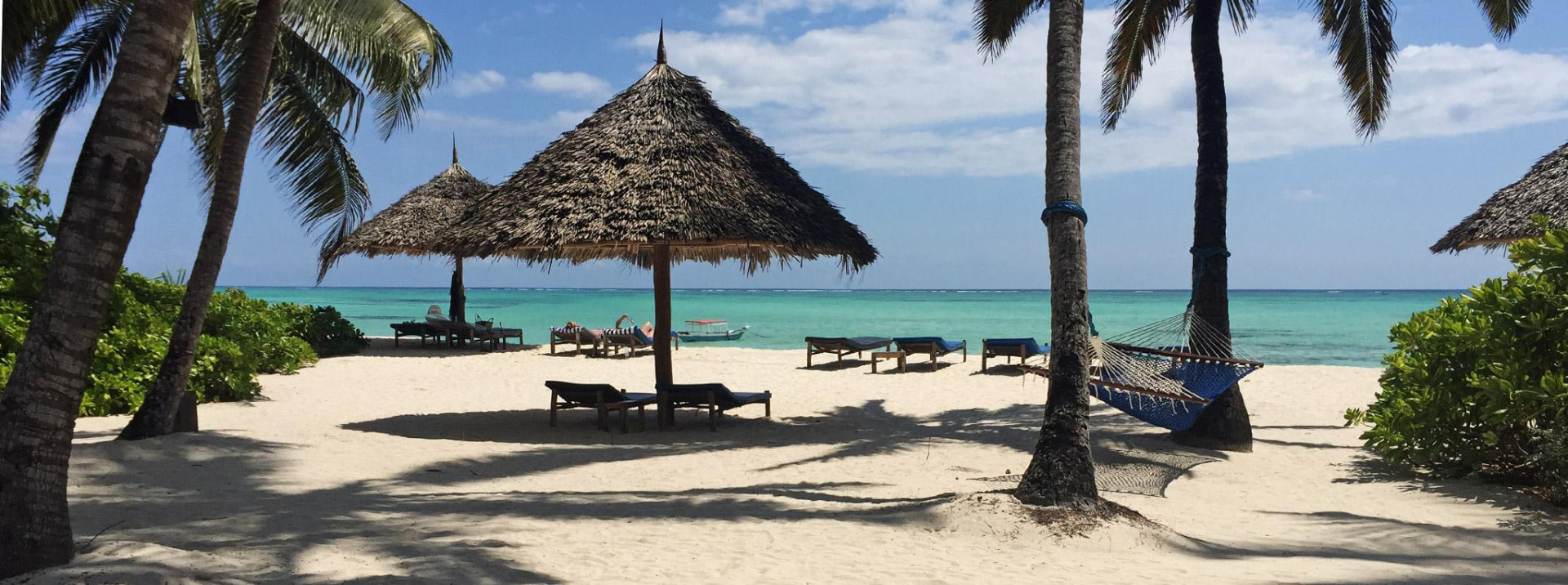 Palm-shaded beach retreat beside turquoise water in Zanzibar