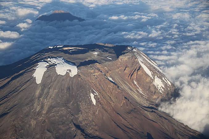 Aerial view of Mount Kilimanjaro's volcanic summit above the clouds